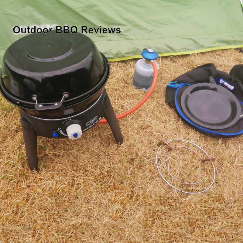 Preparation-Safari-chef-2-low-pressure-bbq-with-gas-canister-pot-stand-and-metalic-plate-on-grass-field-